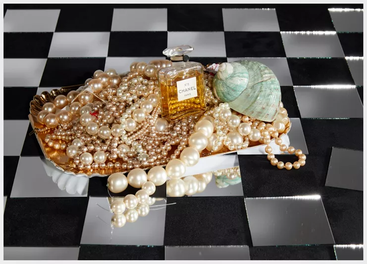 Roe Ethridge, "Chanel No 5 from 1924 on Tray of Pearls and Mirror Checkerboard", 2025. UV-cured pigment print, 50 x 70 inches (127 x 177.8 cm). Edition of 5 + 2 AP