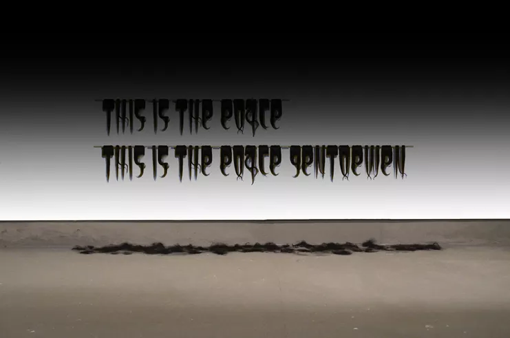 Maria Tsagkari, This Is the Place Gentlemen! , human hair, wooden pole, Athens/GR, 2023. Photo: Courtesy of the artist